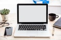 Laptop with white blank screen on a wooden desk Royalty Free Stock Photo