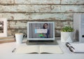 Laptop on a white desk with wood wall. Login screen