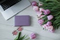 Laptop on white floor with flowers. tulips Royalty Free Stock Photo