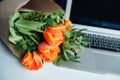 Laptop on white floor with flowers Royalty Free Stock Photo