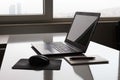 Laptop with white screen mock up template. Office desk with computer; coffee cup and pen Royalty Free Stock Photo