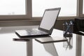 Laptop with white screen mock up template. Office desk with computer; coffee cup and pen Royalty Free Stock Photo