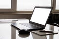 Laptop with white screen mock up template. Office desk with computer; coffee cup and pen Royalty Free Stock Photo