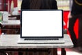 Laptop with white screen on a table in a coffee house Royalty Free Stock Photo