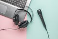 Laptop, wired microphone and headphones on a blue and pink background Royalty Free Stock Photo