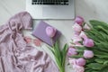 Laptop on wooden floor with coffee tulips and notepad Royalty Free Stock Photo