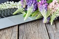 Laptop on wooden floor with flowers Royalty Free Stock Photo