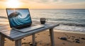 Laptop on a wooden table at a beach during sunset, with a wave Royalty Free Stock Photo