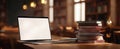 The laptop on a wooden table surrounded by stacks of books in a library..AI generated image Royalty Free Stock Photo