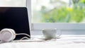 The laptop working on the white bed and coffee in the window on rainy day, Royalty Free Stock Photo