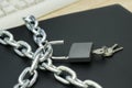 The laptop is wrapped with an iron chain and opened with a padlock with keys the concept of protecting information from Internet Royalty Free Stock Photo