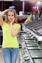 Beautiful girl in the department of laptops in the electronics store. Royalty Free Stock Photo