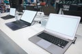 Laptops in a modern technology store. Department of computers in the electronics store. Choosing a laptop in the store Royalty Free Stock Photo