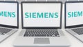 Laptops with Siemens logo on the screen. Computer technology conceptual editorial 3D rendering