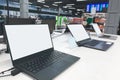 Laptops with a white screen at the showcase in the electronics store. Buy a laptop in a technology store Royalty Free Stock Photo