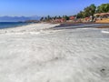 Lara beach covered with sea foam in Antalya, Turkey