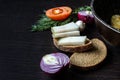 Lard salo with bread with red onions on the background of the tomato with garlic and dill and pan on wooden table Royalty Free Stock Photo