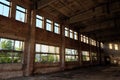 A large abandoned industrial building is lit by light from the windows. Large red brick building Royalty Free Stock Photo