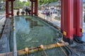 Large ablution basin called chÃÂzuya adorned with a carved minogame turtle in the Dazaifu shrine of Kyushu. Royalty Free Stock Photo