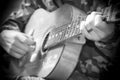 A large acoustic old guitar in the hands