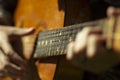 A large acoustic old guitar in the hands