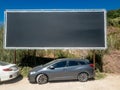 large advertising panel with nothing, just a black image, installed in a public car park in the town of Sesimbra