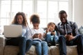 Large African American family using devices, sitting together