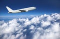 Large airliner along clouds