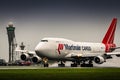 Large airplane taking off with water spray and air traffic control tower in the background. Boeing 747-400 jumbo jet. Royalty Free Stock Photo