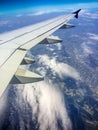 Large Airplane Wing Against Blue Sky and Clouds Royalty Free Stock Photo