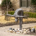 Large aluminum bending diver sculpture in a garden in Dallas, Texas.