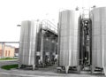 Large aluminum drums tanks and pipelines modern plant for the pr Royalty Free Stock Photo