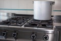 Large aluminum pot over the stove's gas industrial kitchen