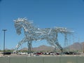 Large aluminum rod abstract horse transparent walking blue sky