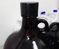 Large amber bottle to contain chemical reagents in a scientific laboratory Royalty Free Stock Photo