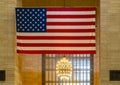 Large American flag and chandelier inside Grand Central Terminal in New York City, New York. Royalty Free Stock Photo