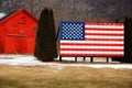 A large American flag stands on a farm in rural New York