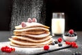 Large American pancakes on a dark background. Breakfast European. Chef sprinkles pancakes with powdered sugar on black Royalty Free Stock Photo