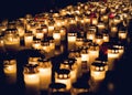 Large amount of lit grave candles at All Saints Day. Royalty Free Stock Photo