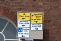 large amount of signs restricted parking no loading on a brick wall Royalty Free Stock Photo