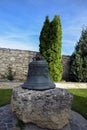 Large  ancient church bell mounted on big stone in orthodox monastery. Close-up. Moldova, Old Orhei Royalty Free Stock Photo
