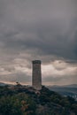 Large ancient stone tower stands on a hill in the forest. Royalty Free Stock Photo