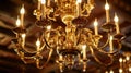 A large antique chandelier hangs from the ceiling its brass arms and candlelike lights casting a warm glow throughout Royalty Free Stock Photo