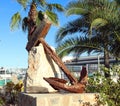 Large antique rusty anchor on a pedestal, monument to navigation, Spain,