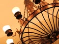 A large antique vintage round metal chandelier of bronze color w Royalty Free Stock Photo