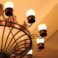 A large antique vintage round metal chandelier of bronze color w Royalty Free Stock Photo