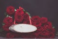 Large armful of red roses with a wooden stylish