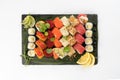 Large assortment of assorted sushi maki made from salmon, tuna, shrimp roe of tobiko flying fish, rice and sesame seeds