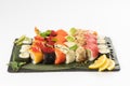 Large assortment of assorted sushi maki made from salmon, tuna, shrimp roe of tobiko flying fish, rice and sesame seeds