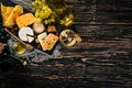 A large assortment of cheeses, brie cheese, gorgonzola, blue cheese, grapes, honey, nuts, red and white wine, on a wooden table. Royalty Free Stock Photo